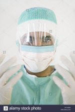 a-doctor-with-a-surgical-mask-and-latex-gloves-ATYAWW.jpg